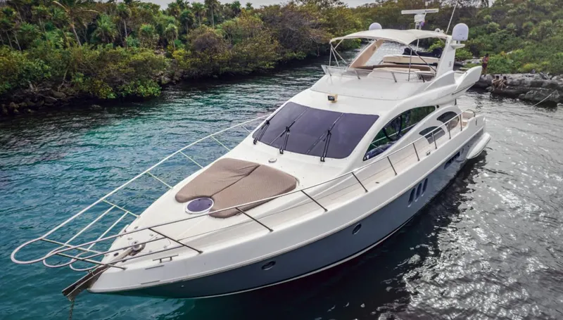 Belle Yacht Photos Pics 2004 Azimut 55E yacht cruising in a serene, tropical waterway.