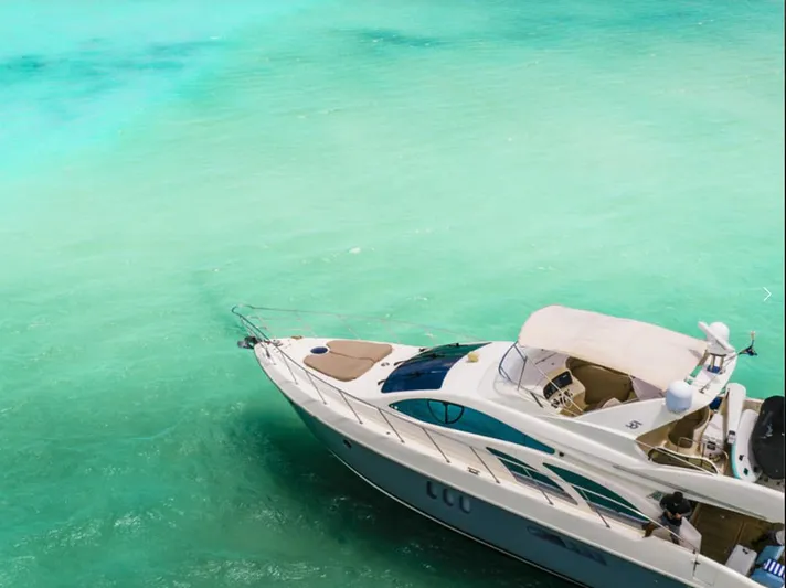 Belle Yacht Photos Pics Luxurious 2004 Azimut 55E yacht cruising in clear turquoise waters.