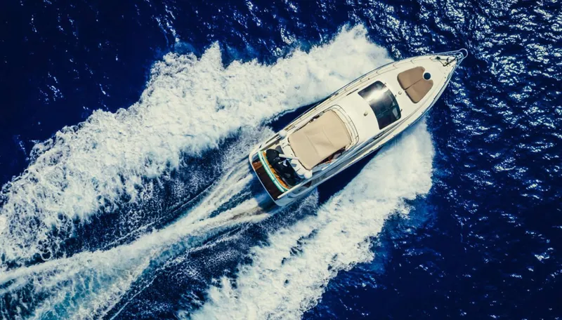 Belle Yacht Photos Pics Aerial view of 2004 Azimut 55E yacht cruising on deep blue ocean waters.