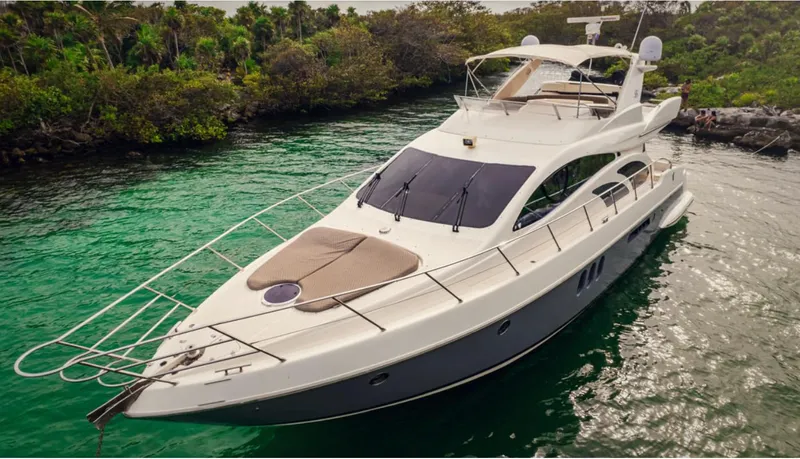 Belle Yacht Photos Pics 2004 Azimut 55E yacht cruising in a lush, tropical waterway.