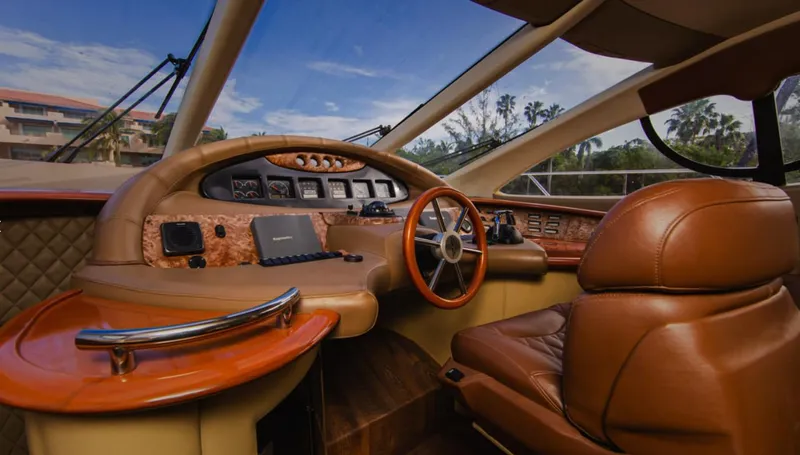 Belle Yacht Photos Pics Luxurious 2004 Azimut 55E yacht helm with leather seating and wood accents.