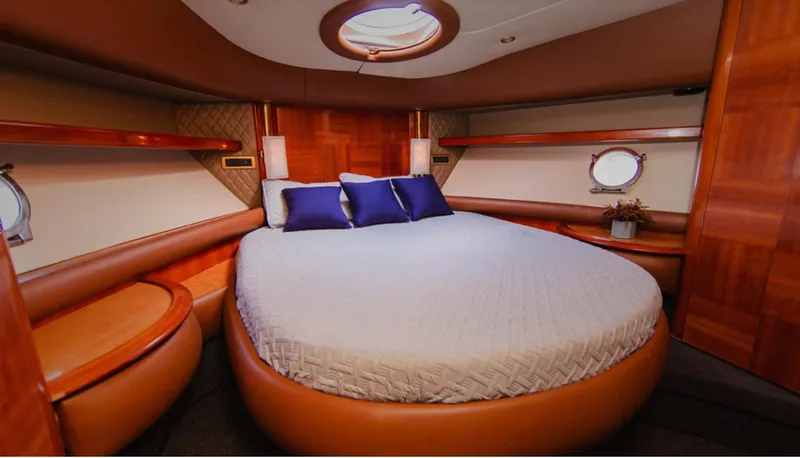 Belle Yacht Photos Pics Luxurious bedroom interior of 2004 Azimut 55E yacht with round bed and elegant wood finish.