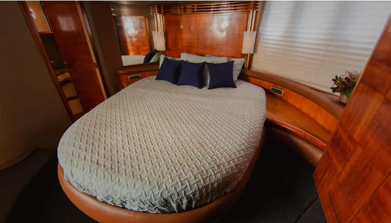 Belle Yacht Photos Pics Luxurious bedroom interior of 2004 Azimut 55E yacht with elegant wood finish and cozy bedding.