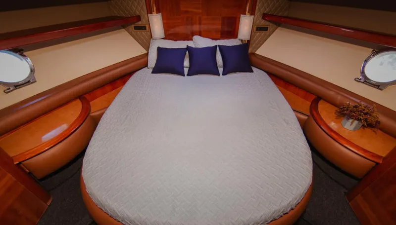 Belle Yacht Photos Pics Luxurious bedroom interior of 2004 Azimut 55E yacht with elegant bedding and wood accents.