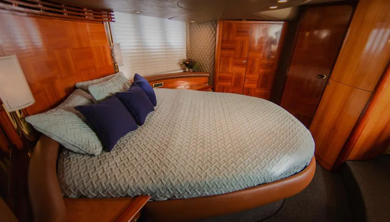 Belle Yacht Photos Pics Luxurious bedroom interior of 2004 Azimut 55E yacht with elegant wood finish.