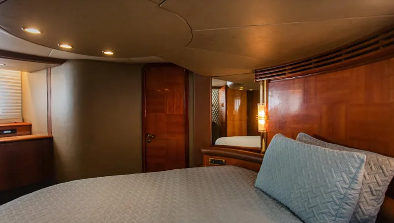 Belle Yacht Photos Pics Luxurious cabin interior of a 2004 Azimut 55E yacht with elegant wood paneling.