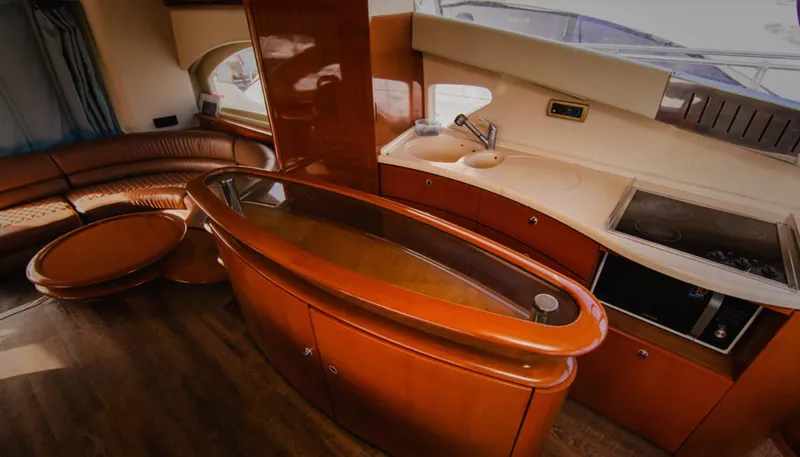 Belle Yacht Photos Pics Luxurious interior of a 2004 Azimut 55E yacht with modern kitchen and seating area.
