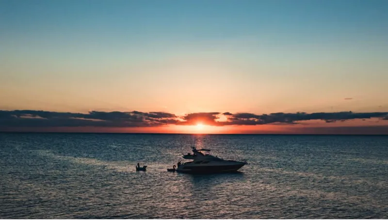 Belle Yacht Photos Pics 2004 Azimut 55E yacht at sunset on calm ocean waters.