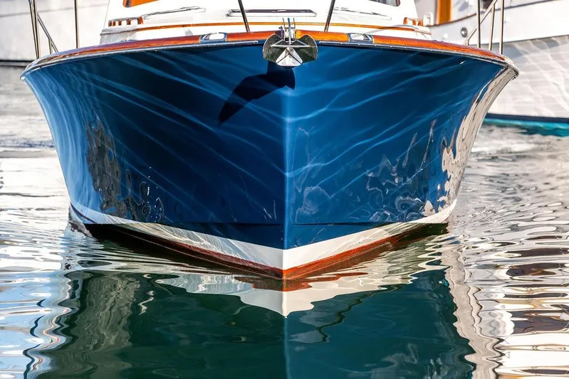 Mon Amour Yacht Photos Pics Front view of a 2005 Hinckley Talaria 44 yacht reflecting on water.