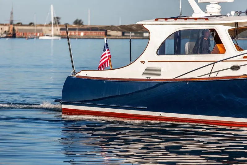 Mon Amour Yacht Photos Pics 2005 Hinckley Talaria 44 yacht cruising on calm waters with American flag.