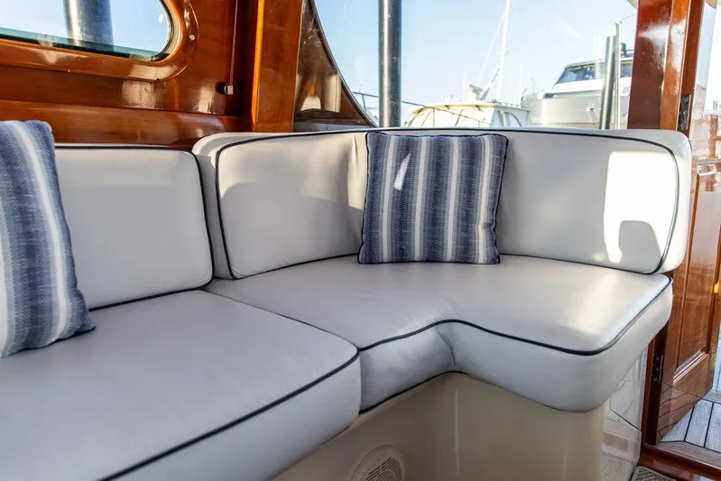 Mon Amour Yacht Photos Pics Luxurious seating area on a 2005 Hinckley Talaria 44 yacht with striped cushions.
