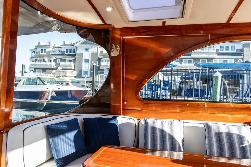 Mon Amour Yacht Photos Pics Interior of 2005 Hinckley Talaria 44 yacht with elegant wood finish and marina view.