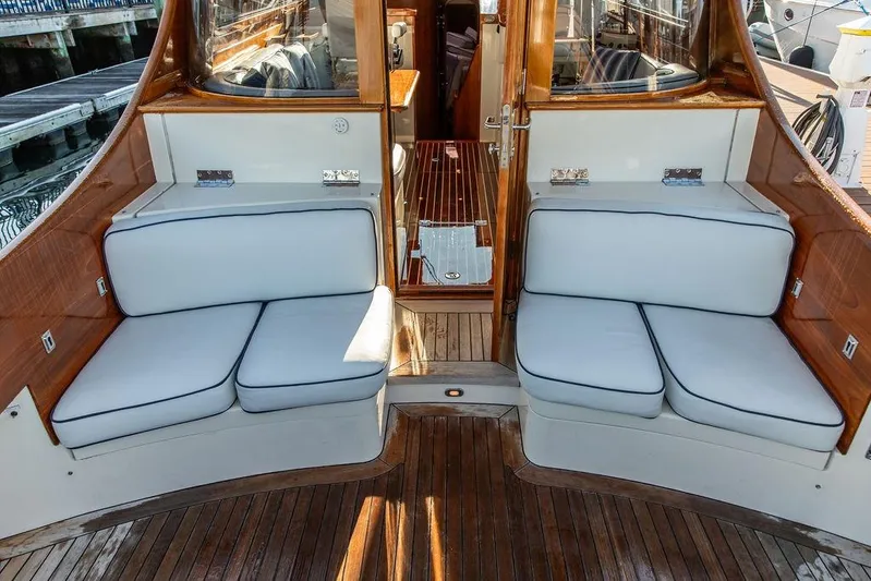Mon Amour Yacht Photos Pics Luxury seating area on a 2005 Hinckley Talaria 44 yacht with wooden accents.