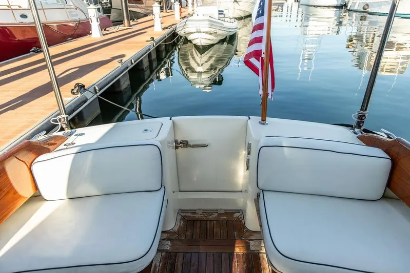 Mon Amour Yacht Photos Pics 2005 Hinckley Talaria 44 yacht with white seating and American flag at marina.
