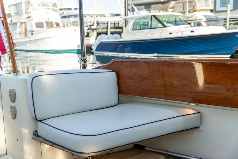 Mon Amour Yacht Photos Pics Hinckley Talaria 44 (2005) boat interior with white cushioned seating and wooden accents.