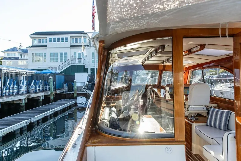 Mon Amour Yacht Photos Pics 2005 Hinckley Talaria 44 yacht docked near waterfront buildings.