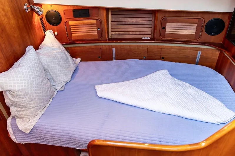 Mon Amour Yacht Photos Pics Cozy cabin interior of 2005 Hinckley Talaria 44 yacht with blue bedding.