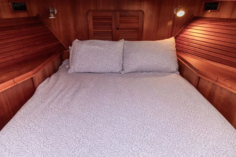 Mon Amour Yacht Photos Pics Luxurious cabin interior of 2005 Hinckley Talaria 44 yacht with cozy bedding.