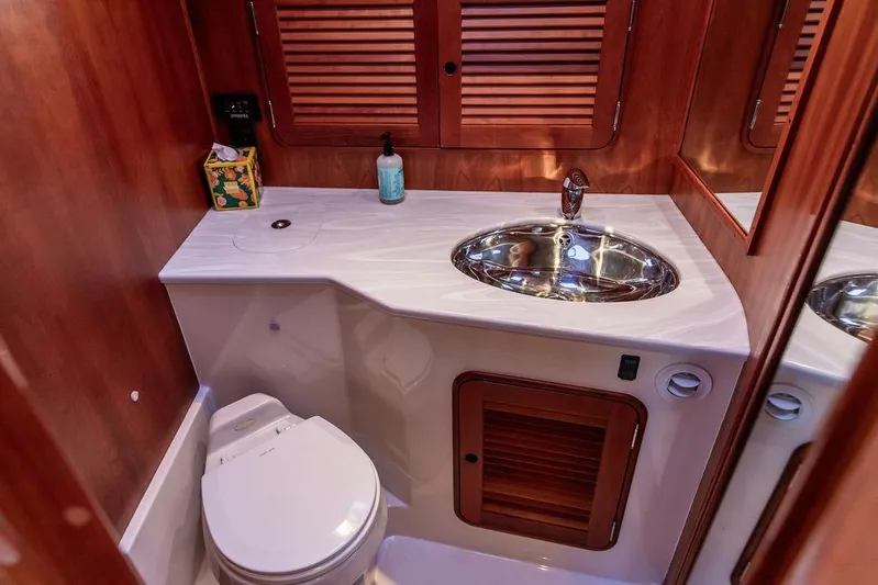 Mon Amour Yacht Photos Pics Luxurious 2005 Hinckley Talaria 44 yacht bathroom with wood accents and modern fixtures.
