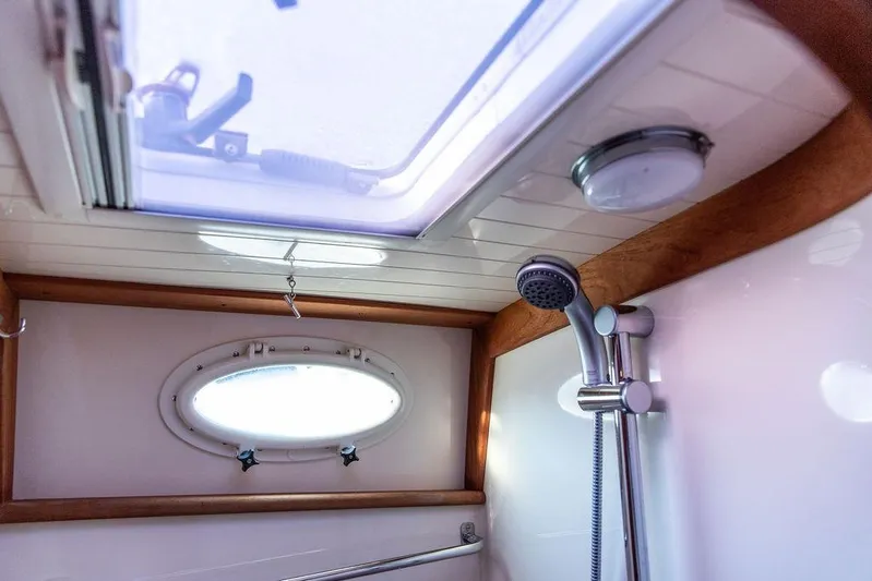 Mon Amour Yacht Photos Pics Interior of 2005 Hinckley Talaria 44 yacht shower with skylight and porthole.