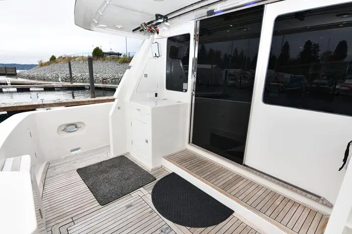  Yacht Photos Pics 2001 Symbol Raised Pilothouse Motoryacht deck with wood flooring and sliding glass doors.