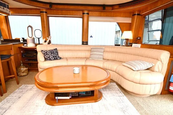 Yacht Photos Pics Luxurious interior of 2001 Symbol Raised Pilothouse Motoryacht with plush seating and wooden accents.