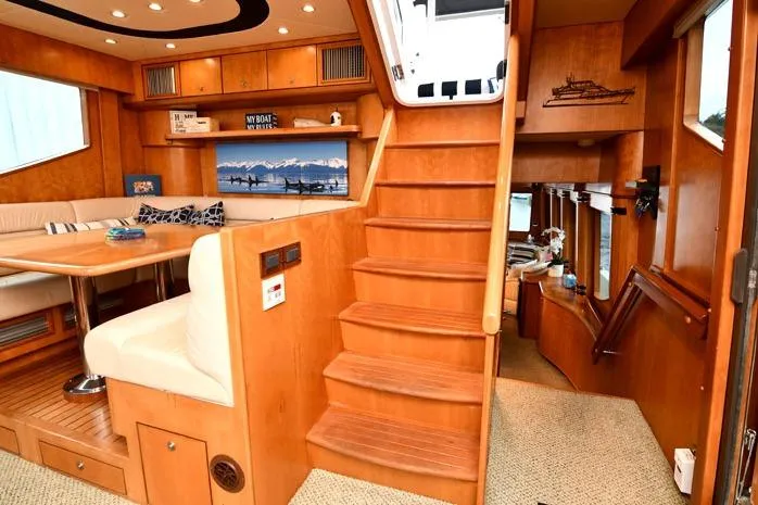  Yacht Photos Pics Interior of 2001 Symbol Raised Pilothouse Motoryacht with wooden stairs and seating area.