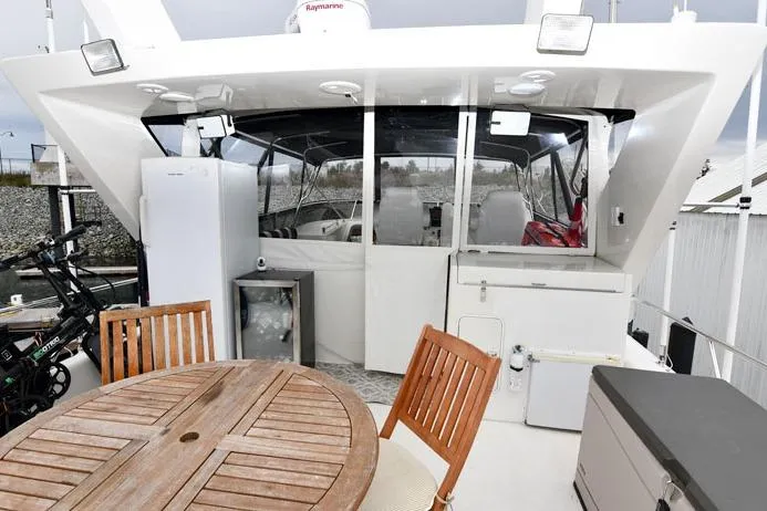  Yacht Photos Pics 2001 Symbol Raised Pilothouse Motoryacht with outdoor seating and modern amenities.
