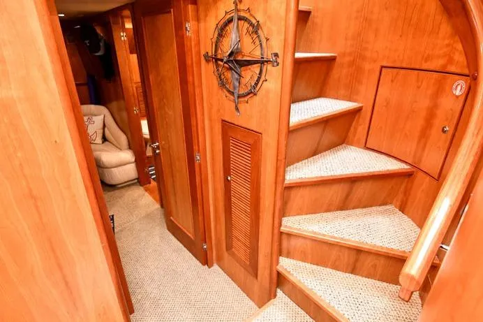  Yacht Photos Pics Luxurious wooden interior of 2001 Symbol Raised Pilothouse Motoryacht with spiral staircase.