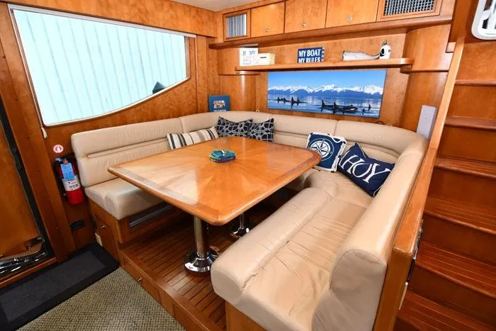  Yacht Photos Pics Luxurious 2001 Symbol Raised Pilothouse Motoryacht interior with elegant dining area and plush seating.