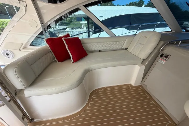  Yacht Photos Pics Luxurious seating area on a 2006 Sea Ray 48 Sundancer yacht with red accent pillows.