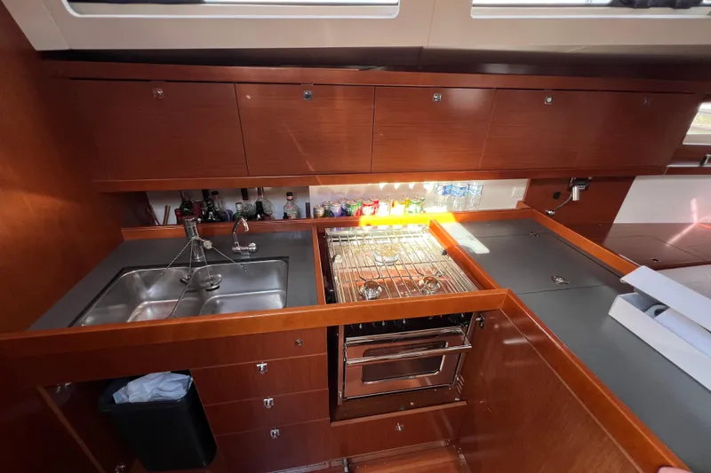 Adattare Yacht Photos Pics Luxurious 2012 Beneteau Oceanis 45 yacht kitchen with modern amenities and sleek wood cabinetry.