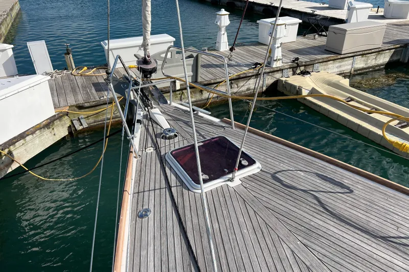 Adattare Yacht Photos Pics Beneteau Oceanis 45 sailboat docked, showcasing deck and marina surroundings, 2012 model.