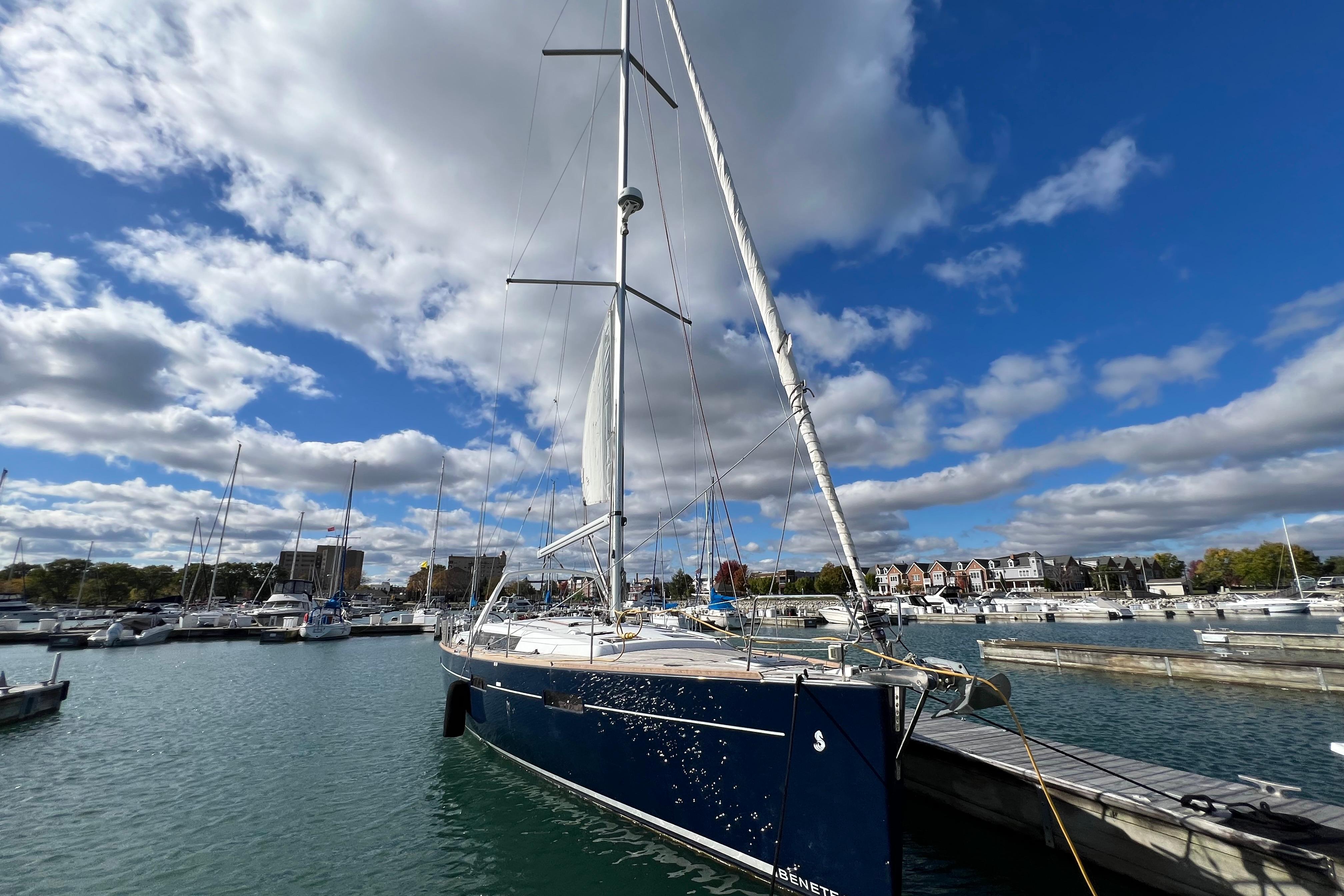 2012 Beneteau Oceanis 45 sailboat docked in a marina under a partly cloudy sky.