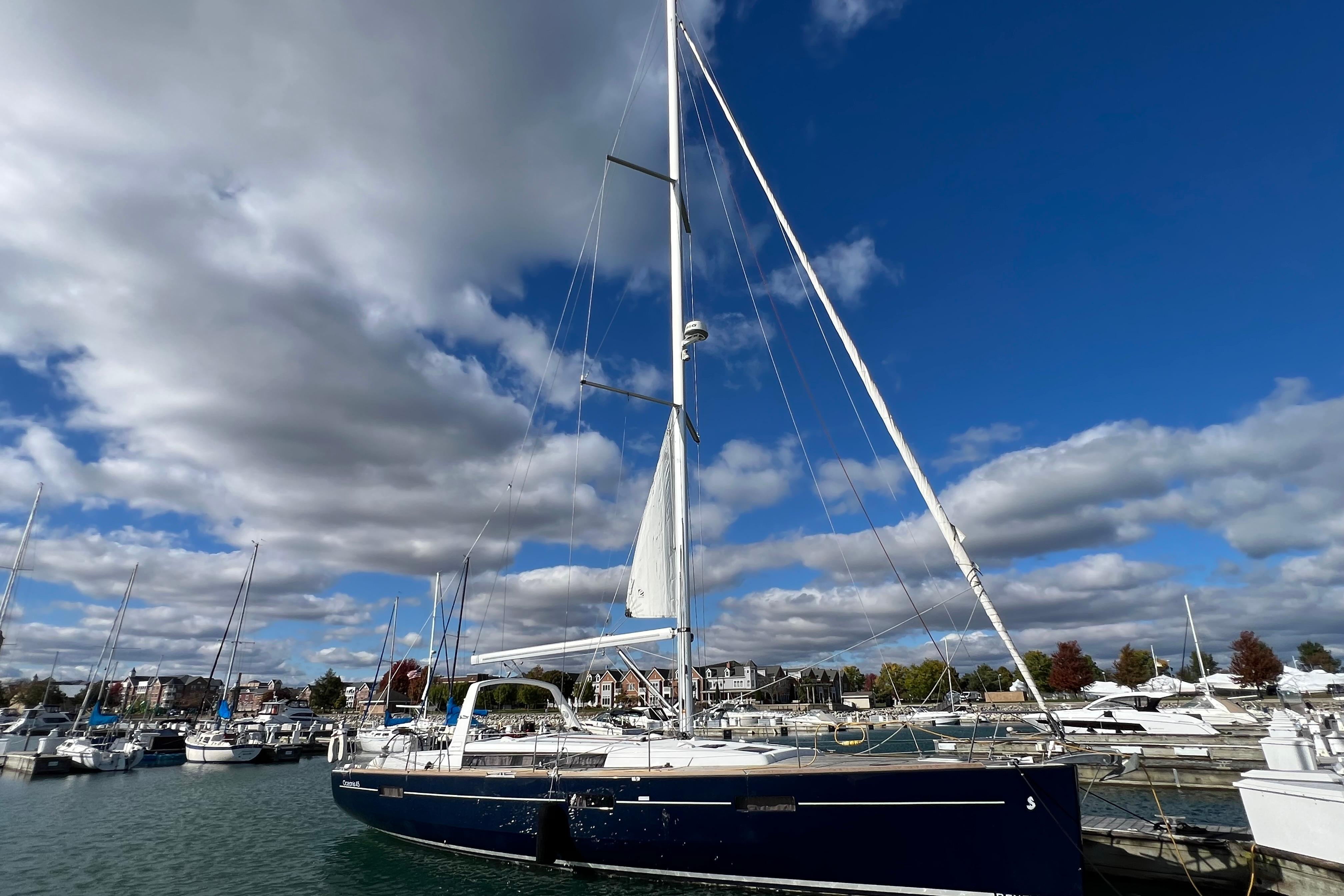 2012 Beneteau Oceanis 45 sailboat docked in a marina under a cloudy sky.