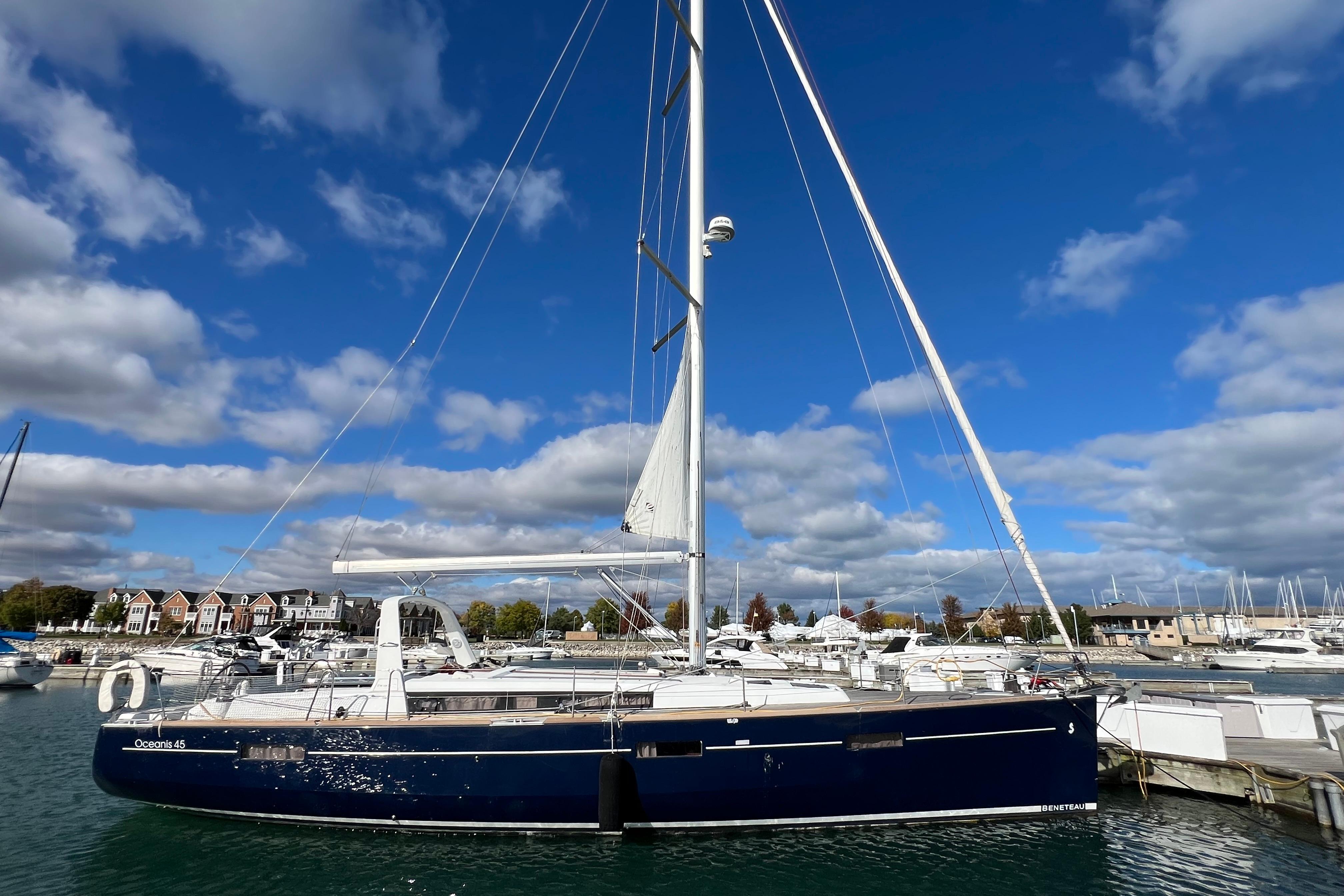2012 Beneteau Oceanis 45 sailboat docked under a vibrant blue sky.