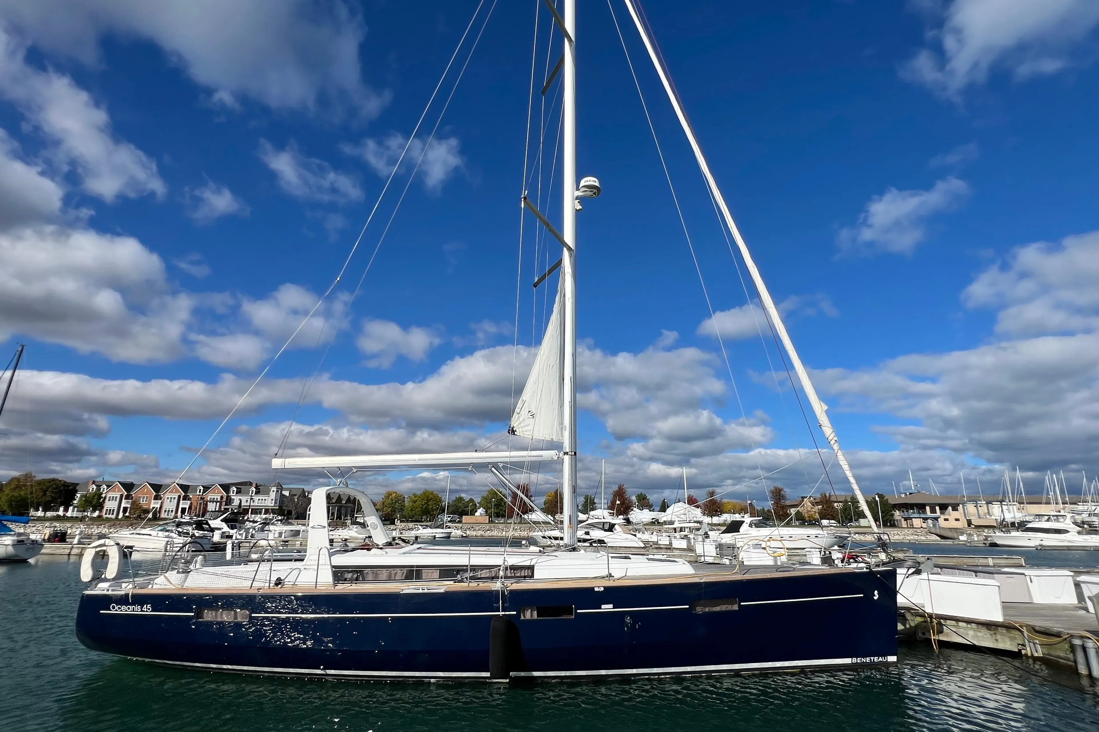 2012 Beneteau Oceanis 45 sailboat docked under a vibrant blue sky.