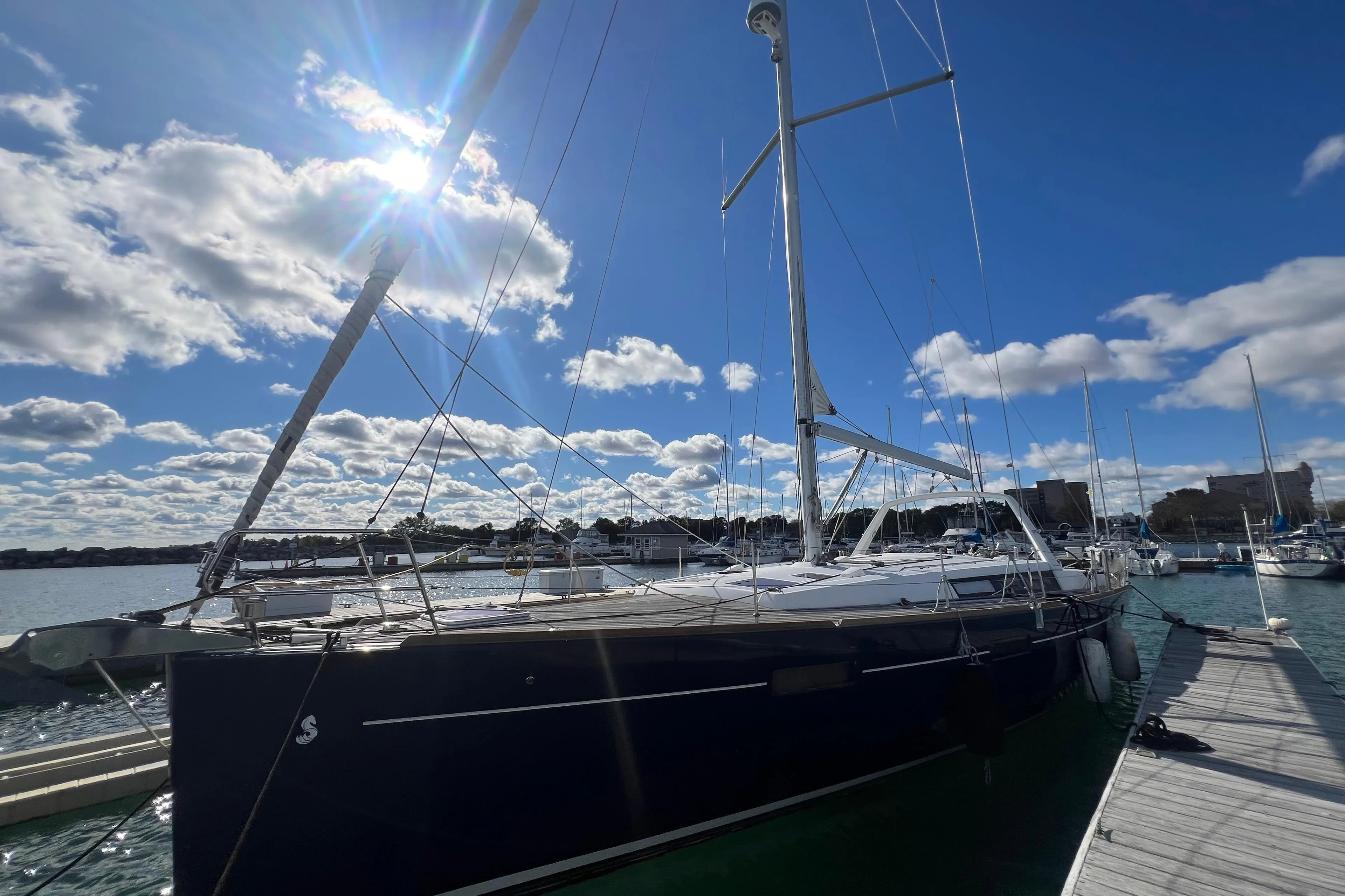 2012 Beneteau Oceanis 45 sailboat docked under a bright blue sky.