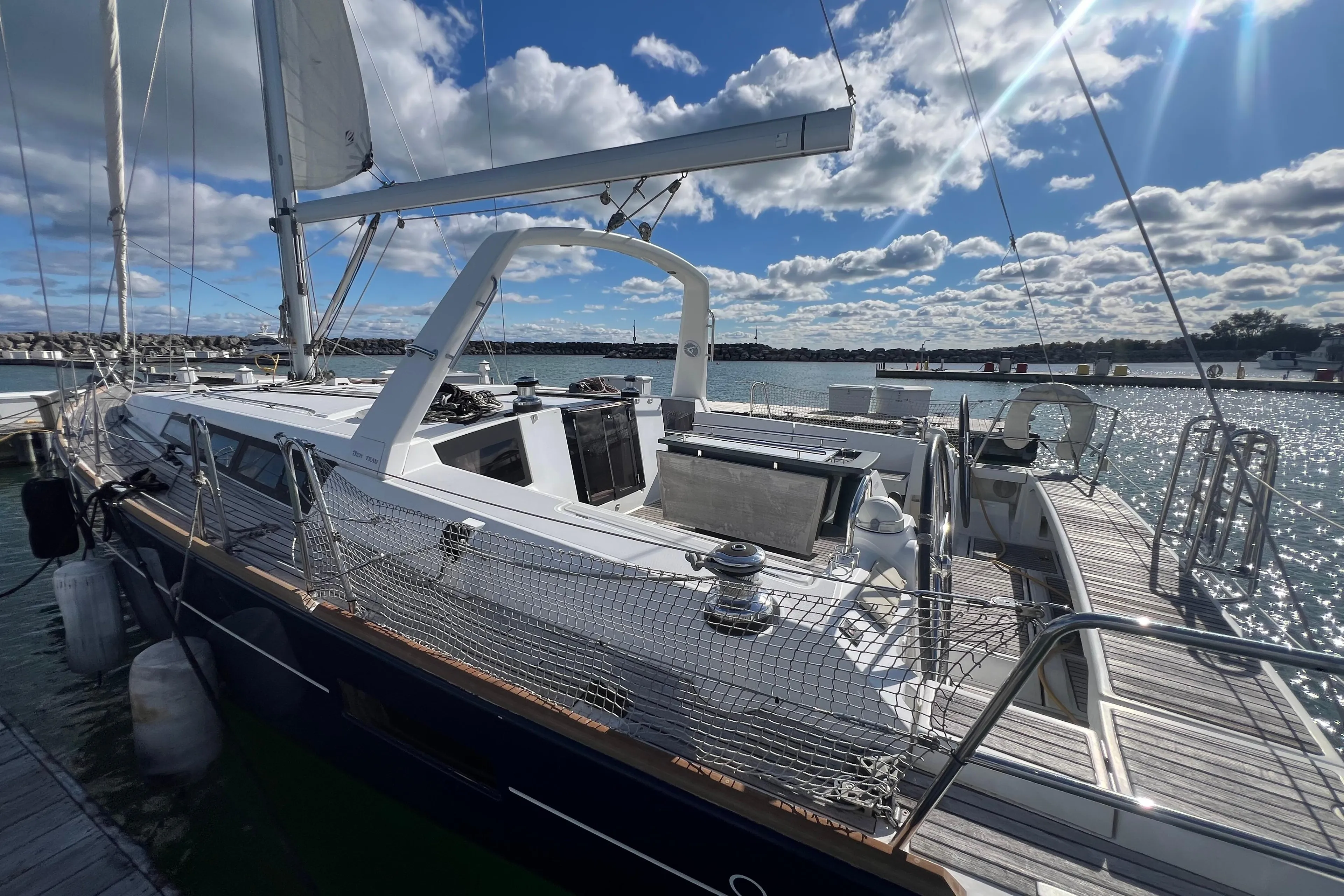 2012 Beneteau Oceanis 45 sailboat docked under a bright blue sky.