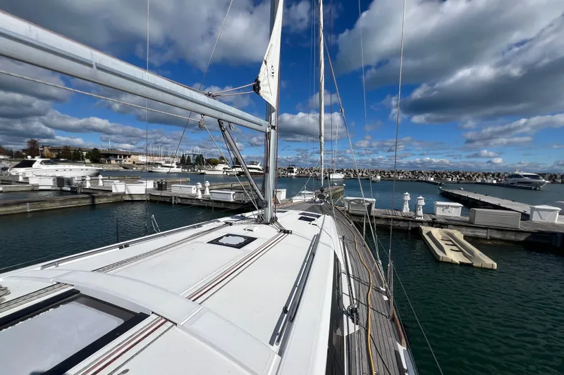 Adattare Yacht Photos Pics Beneteau Oceanis 45 sailboat docked at marina, 2012 model, under a partly cloudy sky.