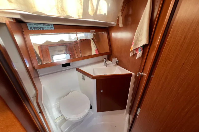 Adattare Yacht Photos Pics Beneteau Oceanis 45 2012 yacht bathroom with wooden cabinetry and compact design.