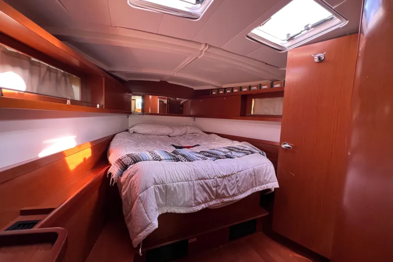 Adattare Yacht Photos Pics Cozy cabin interior of 2012 Beneteau Oceanis 45 sailboat with bed and wooden finish.