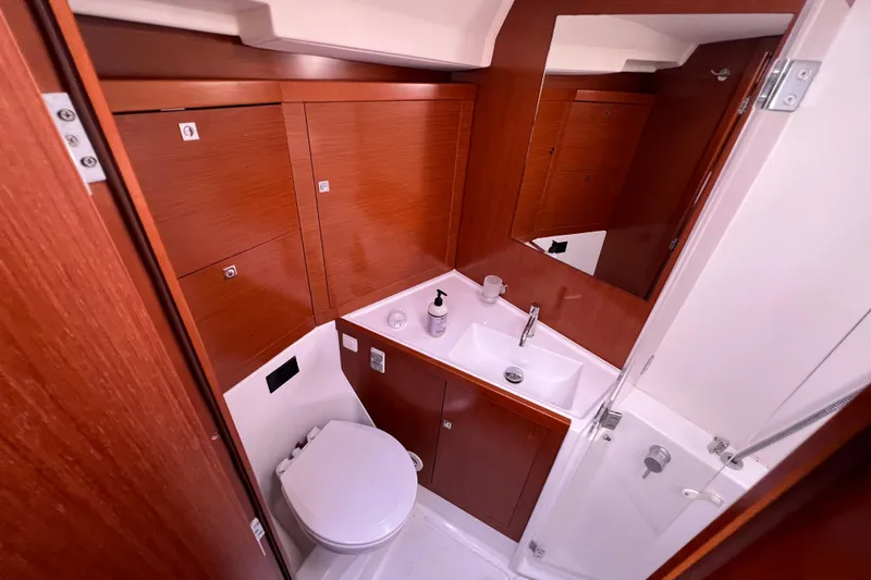 Adattare Yacht Photos Pics Beneteau Oceanis 45 2012 yacht bathroom with wooden cabinetry and modern fixtures.