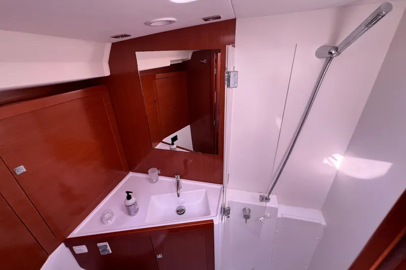 Adattare Yacht Photos Pics Luxurious bathroom in 2012 Beneteau Oceanis 45 yacht with modern fixtures and wood accents.