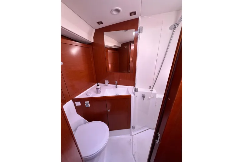 Adattare Yacht Photos Pics Luxurious bathroom in 2012 Beneteau Oceanis 45 yacht with wood accents and modern fixtures.