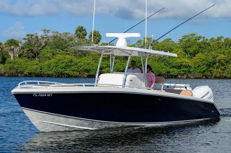  Yacht Photos Pics 2005 Venture 34 Center Console boat cruising on a calm waterway with lush greenery.