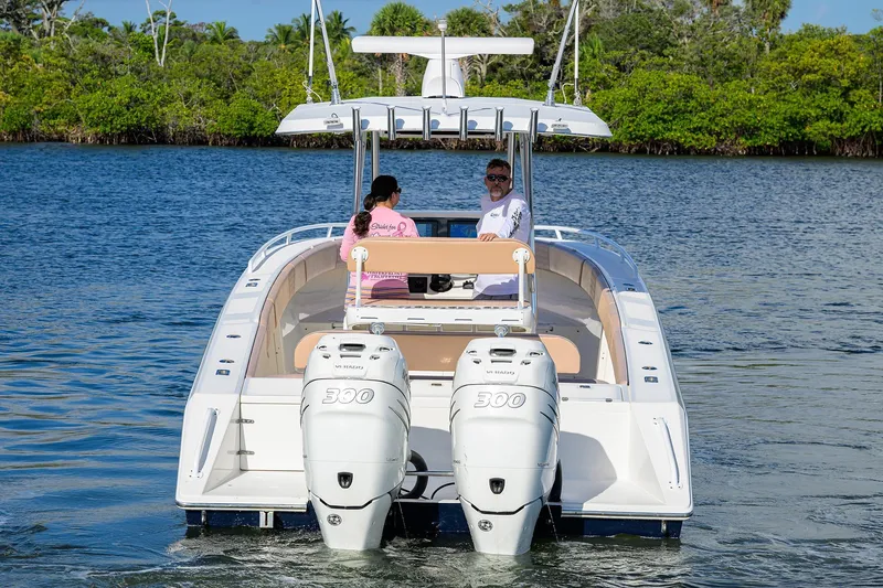  Yacht Photos Pics 2005 Venture 34 Center Console boat with dual engines on a scenic waterway.