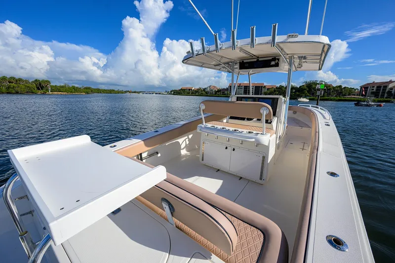  Yacht Photos Pics 2005 Venture 34 Center Console boat on calm water under a clear blue sky.