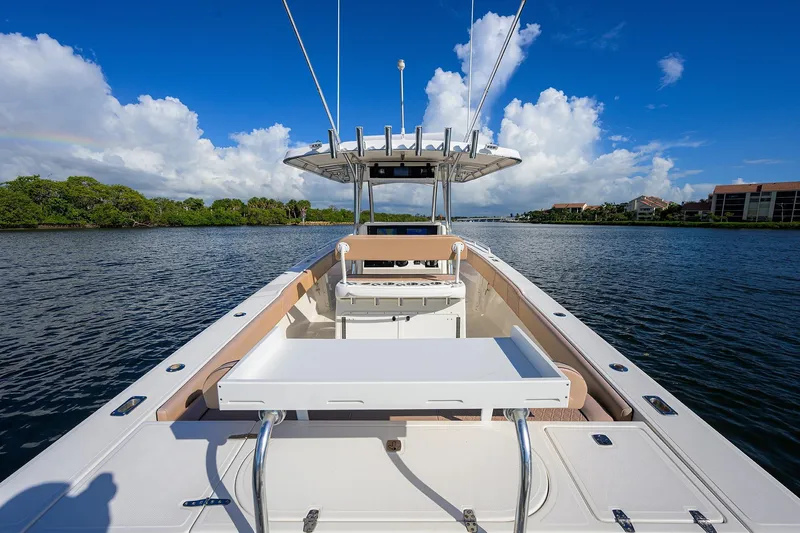  Yacht Photos Pics 2005 Venture 34 Center Console boat on calm water under blue sky.