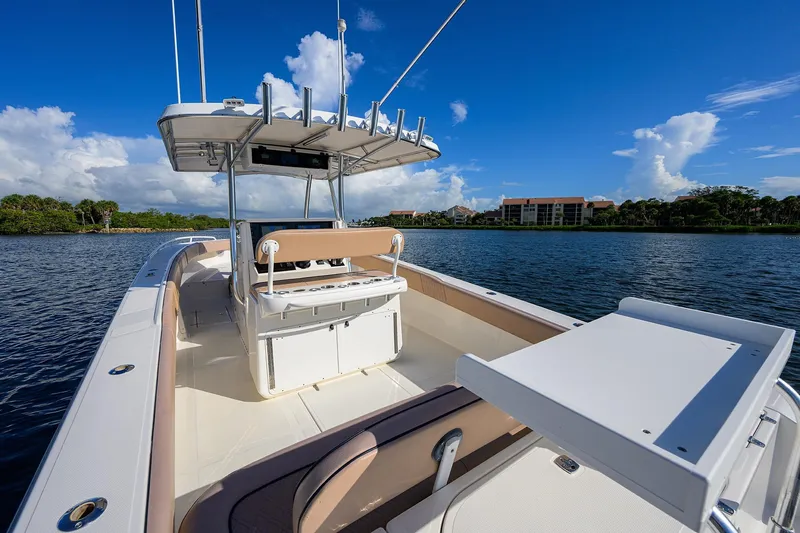  Yacht Photos Pics 2005 Venture 34 Center Console boat on calm water, clear sky, and scenic background.